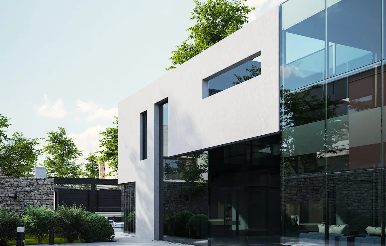 A white building with a large window and trees